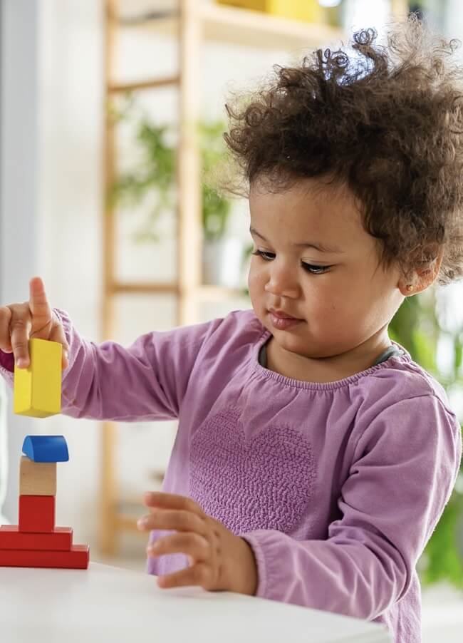 A young child playing with blocks